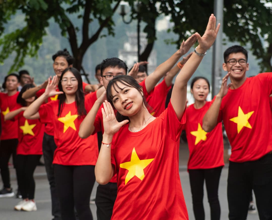 Young Vietnamese people wearing national flag to celebrate the Independence Day