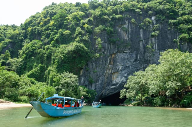 Wooden boat trip along the Son River into Phong Nha Cave in the Phong Nha - Ke Bang National Park in Vietnam