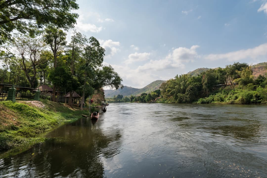 Scenery of mountain and water flowing on riverside